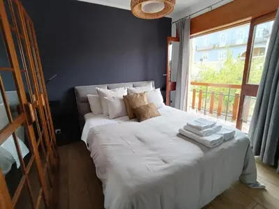 a bedroom with a large white bed with towels on it at Douro Exclusive View in Vila Nova de Gaia