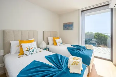 a bedroom with a bed and a large window at Gaia Land Sea View Apartment in Vila Nova de Gaia