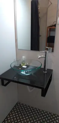 a glass sink in a bathroom with a mirror at Trindade Apartment in Porto
