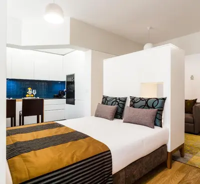 a bedroom with a large bed and a kitchen at Oportolazaro Premium Downtown Porto in Porto