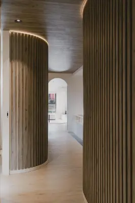 a hallway with a large wooden column in a building at ORM - Santa Teresa Apartments in Porto