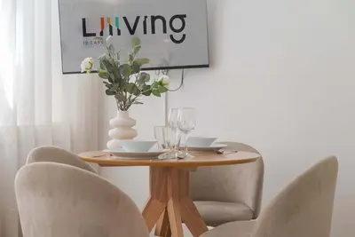 a dining room table with chairs and a vase with flowers at Liiiving in Porto - Urban Retreat Apartment in Porto