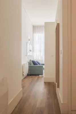 a living room with a blue couch and wooden floors at Liiiving in Porto - Urban Retreat Apartment in Porto