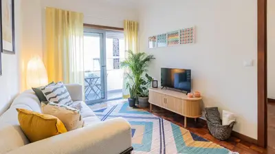 a living room with a couch and a flat screen tv at Adorable apartment center Nao in Porto