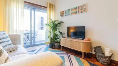 a living room with a flat screen tv on a table at Adorable apartment center Nao in Porto