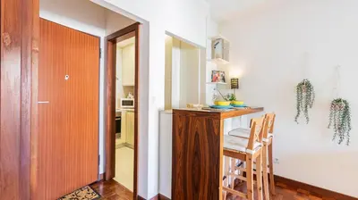 a kitchen with a counter and a table with chairs at Adorable apartment center Nao in Porto