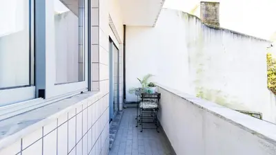 a small balcony with a table and chairs at Adorable apartment center Nao in Porto