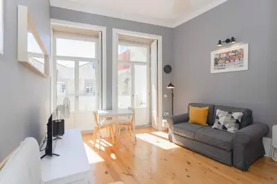 a kitchen and living room with a tv and a couch at Liiiving in Porto - Silver Light Apartment in Porto