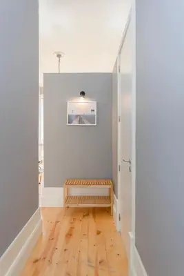 a hallway with a wooden bench in a room at Liiiving in Porto - Silver Light Apartment in Porto