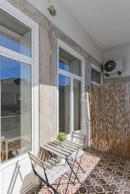 a white bathroom with a sink and a shower at Liiiving in Porto - Silver Light Apartment in Porto