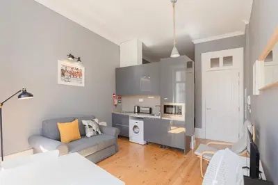 a living room with a couch and a kitchen at Liiiving in Porto - Silver Light Apartment in Porto
