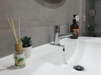 a bathroom sink with a faucet and a bottle of soap at Charming Apartment in the Heart of Historic Porto in Porto