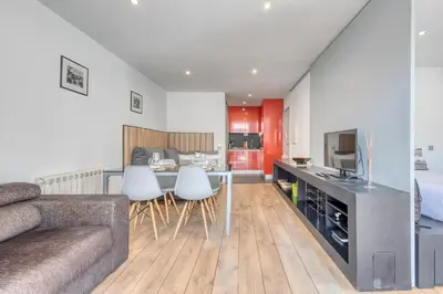 a kitchen and living room with a couch and a table at Ribeira Dreams in Porto