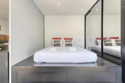 a bedroom with a large bed and a couch at Ribeira Dreams in Porto