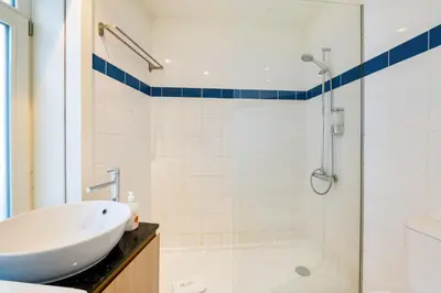 a white bathroom with a sink and a shower at GuestReady - Douro Nest Apartments in Vila Nova de Gaia