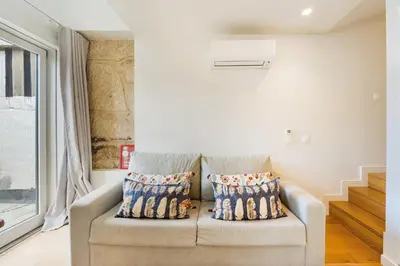 a living room with a couch and a window at GuestReady - Douro Nest Apartments in Vila Nova de Gaia