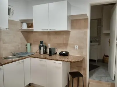 a kitchen with white cabinets and a counter top at Nice Belmonte Flat in Porto