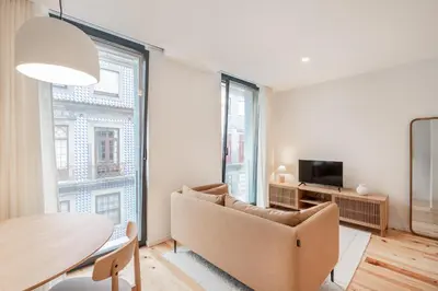 a living room with a couch and a table at VIVA Central Downtown Studio in Porto