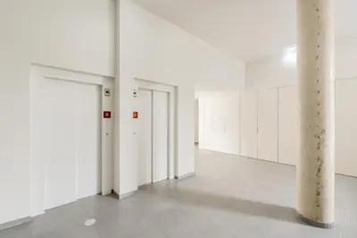 a white room with white doors and a pillar at VIVA Central Downtown Studio in Porto