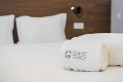 a pile of towels sitting on top of a bed at GuestReady - Stylish base steps from attractions in Porto