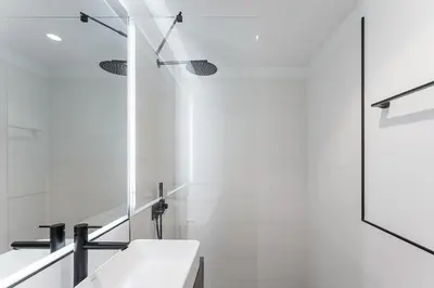 a white bathroom with a sink and a mirror at GuestReady - Stylish base steps from attractions in Porto