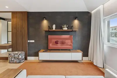 a living room with a tv on a wall at GuestReady - Stylish base steps from attractions in Porto