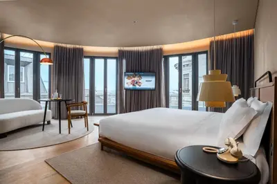 a hotel room with a large bed and a room with a view at Akeah Porto Centro in Porto