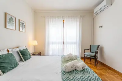 a bedroom with a bed with towels on it at GuestReady - Home Comforts in Porto in Porto