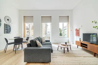 a living room with a couch and a table at Bright Studio in Porto in Porto