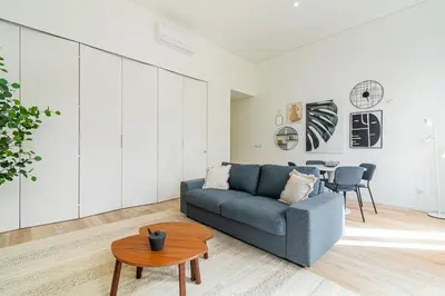 a living room with a couch and a table at Bright Studio in Porto in Porto