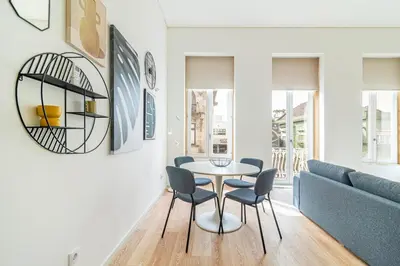 a living room with a table and chairs and a couch at Bright Studio in Porto in Porto