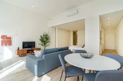 a living room with a couch and a table at Bright Studio in Porto in Porto