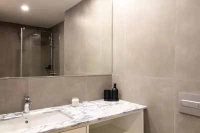 a bathroom with a sink and a mirror at Stylish & Cozy 1BR with AC by LovelyStay in Porto