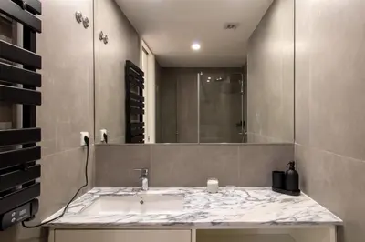 a bathroom with a sink and a mirror at Stylish & Cozy 1BR with AC by LovelyStay in Porto