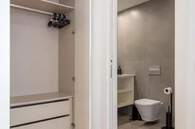 a bathroom with a toilet and a sink at Stylish & Cozy 1BR with AC by LovelyStay in Porto