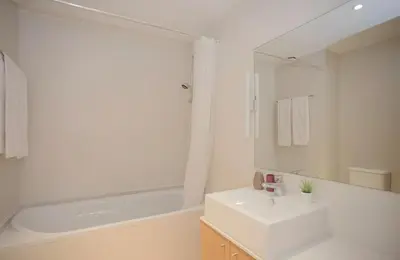 a white bathroom with a sink and a bath tub at Oporto Blue Dragão - Modern Uptown Studio With Free Parking in Porto