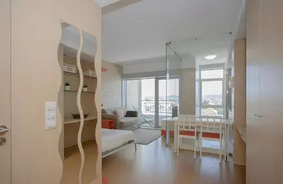 a living room with a couch and a table at Oporto Blue Dragão - Modern Uptown Studio With Free Parking in Porto