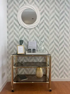 a dressing table with a mirror on a striped wall at Porto Family Home Apartment in Porto