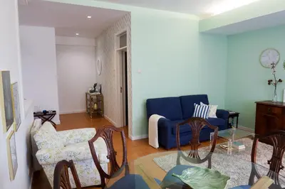 a living room with a blue couch and chairs at Porto Family Home Apartment in Porto