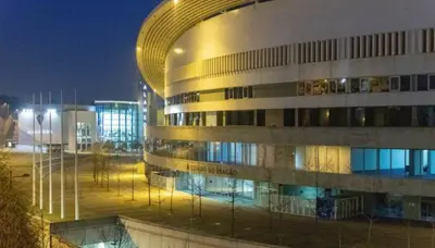 a large building with a lit up facade at night at Porto H Dragão in Porto