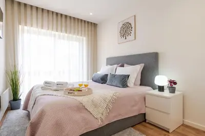 a bedroom with a bed with a tray on it at Central & Stylish Apartment by HostWise in Porto