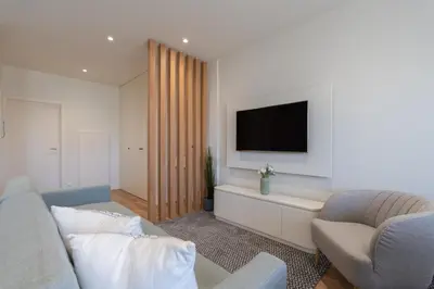 a living room with a couch and a tv at Central & Stylish Apartment by HostWise in Porto