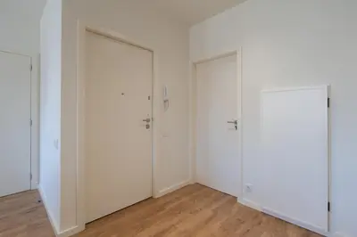 two doors in a white room with wood floors at Central & Stylish Apartment by HostWise in Porto