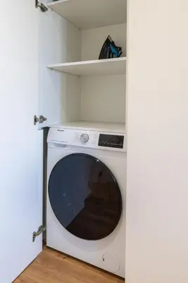 a washer and dryer sitting in a room at Central & Stylish Apartment by HostWise in Porto