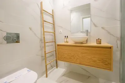 a bathroom with a sink and a mirror at Art Deco 14 Luxury Apartment Downtown Metro AC in Porto