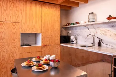 a kitchen with a table with plates of food on it at Chic Campanhã Home w Free Parking by LovelyStay in Porto