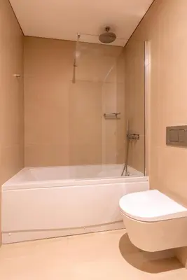 a bathroom with a white tub and a toilet at Stylish Home with Balcony & Garage by HostWise in Porto