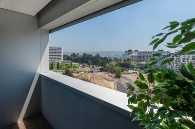 a balcony with a view of a city at Stylish Home with Balcony & Garage by HostWise in Porto
