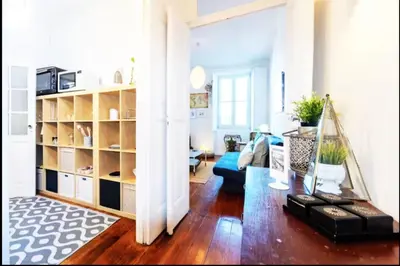 a living room with a couch and a book shelf at Love&Life - Cosy&Central in Porto