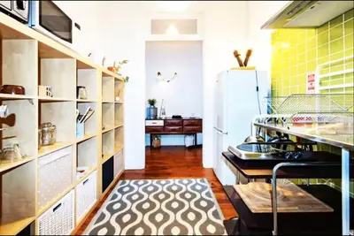 a kitchen with a refrigerator and a table in it at Love&Life - Cosy&Central in Porto